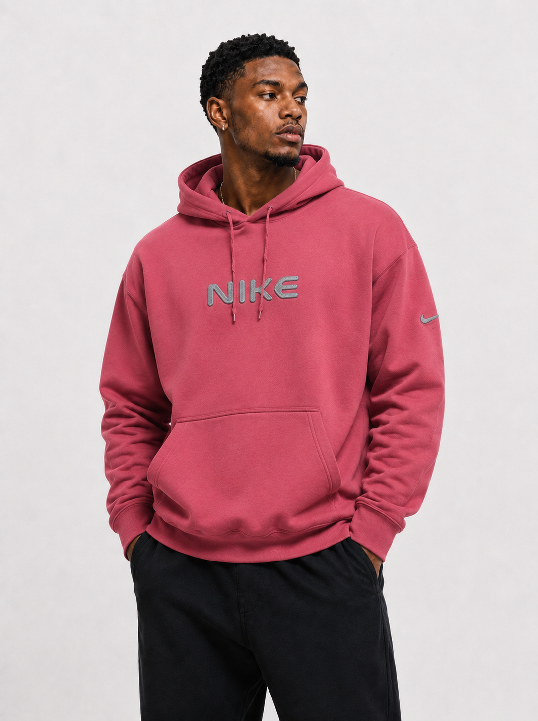 Front view of a Person wearing a pink red Nike hoodie on a white background