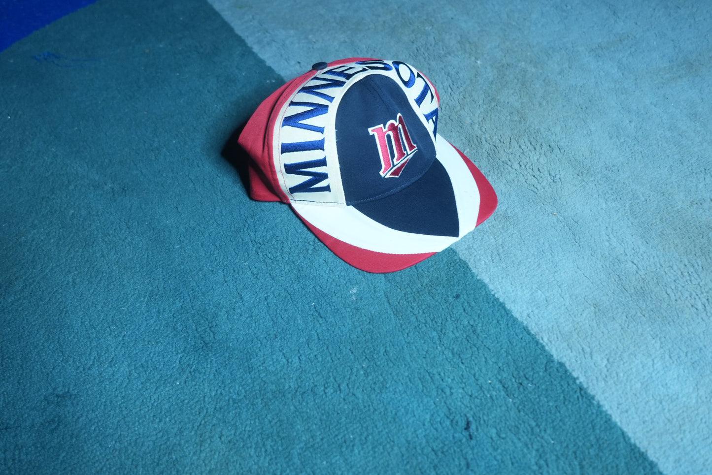 Side view of a vintage 90s Minnesota Twins MLB baseball snapback hat with embroidered graphic brim
