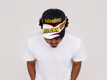 Top down view of a vintage Ricky Rudd Valvoline NASCAR racing snapback hat with graphic brim design
